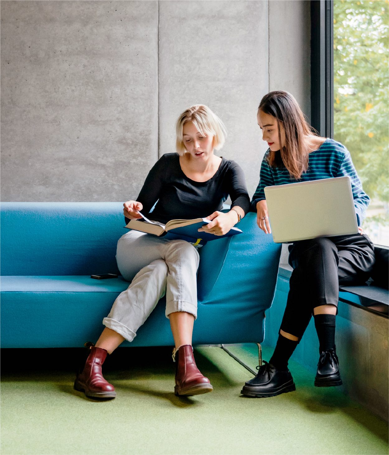 Deux femmes dans une salle de repos collaborant sur un projet.